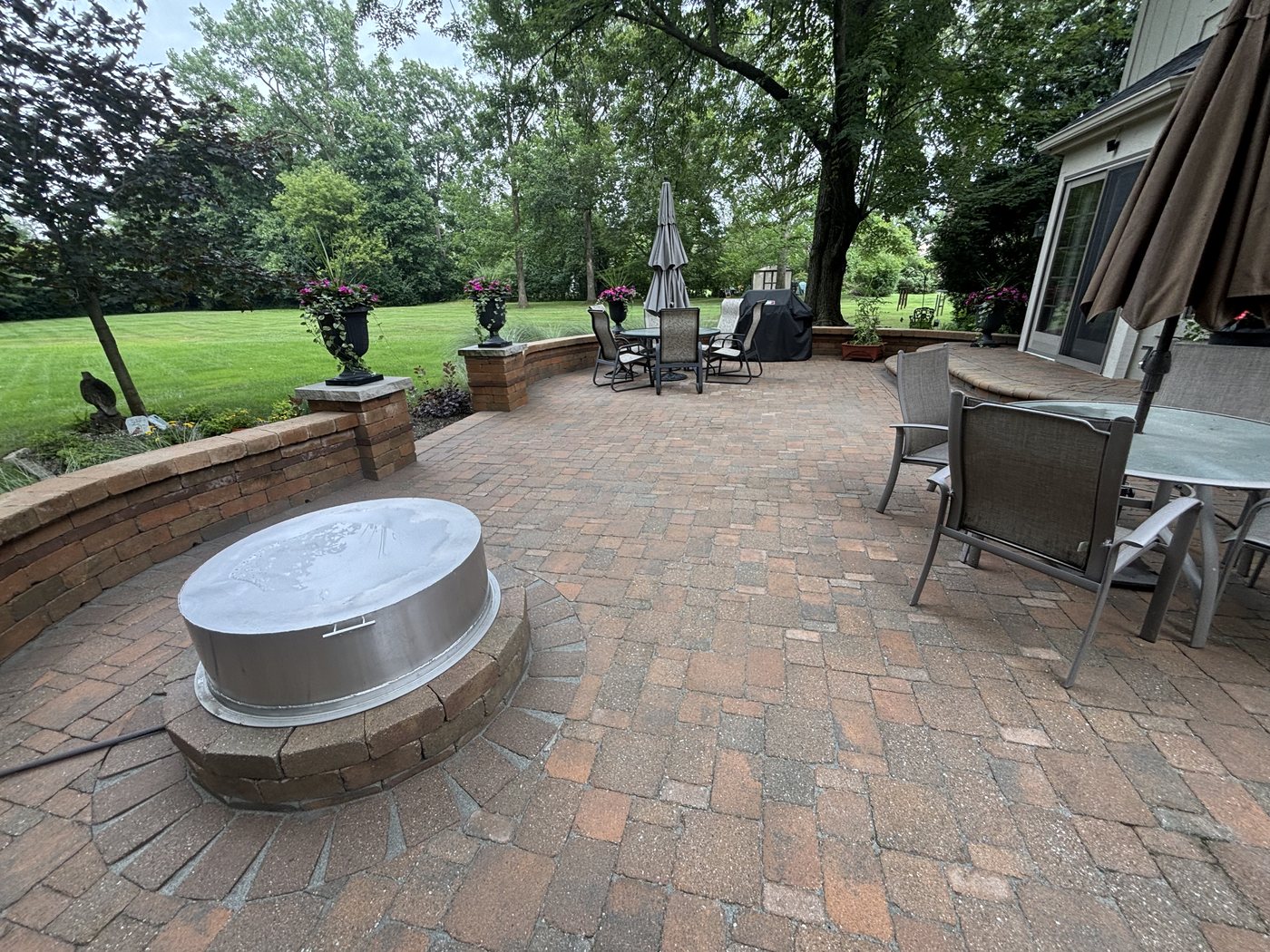 Paver patio with fire pit and seating wall